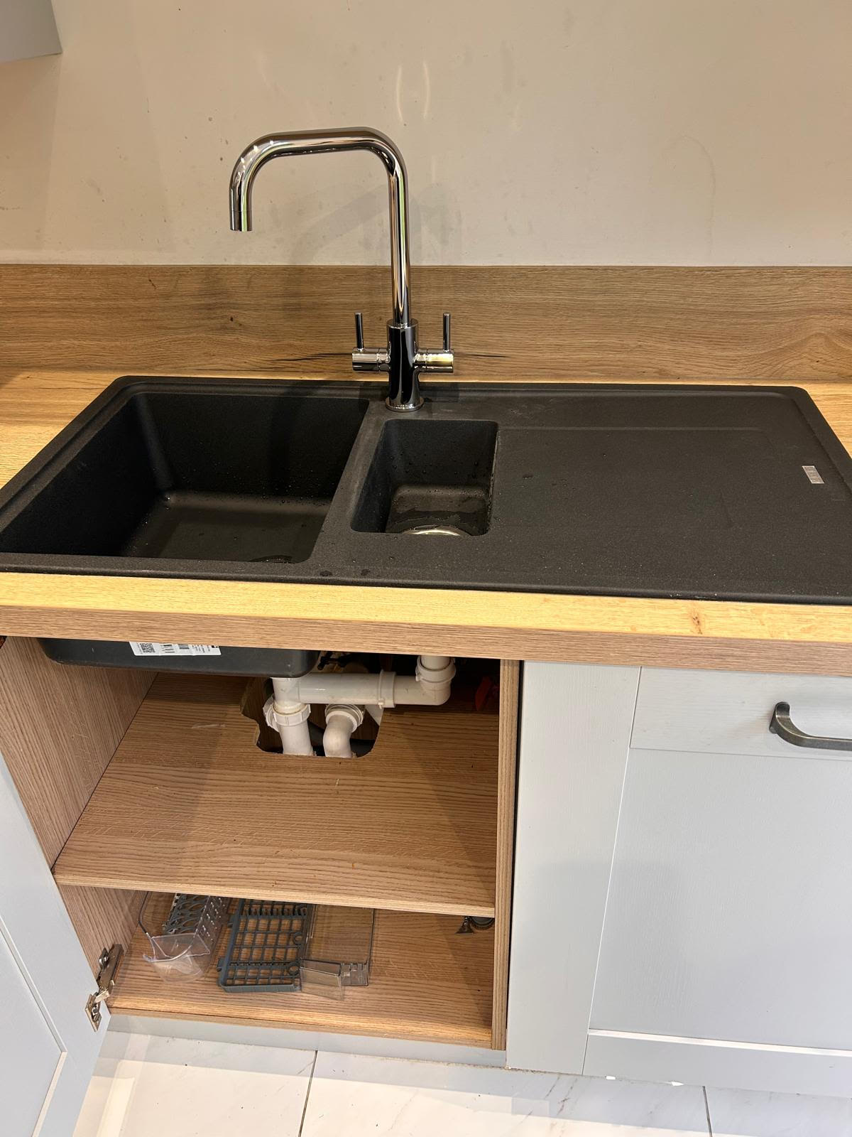 Freshly installed kitchen sink with chrome tap